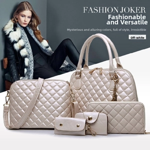 Detail view of 5-piece cream white quilted handbag set with golden hardware accents