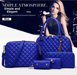 Detail of five-piece blue tote bag set featuring quilted diamond stitching and gold accents