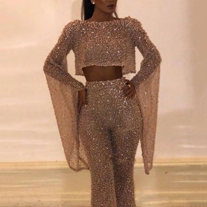Sparkly champagne gold sequin set featuring long sleeve crop top and flared trousers