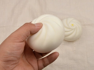 Squishy bun toy made of PU material being squeezed to show slow rebound feature