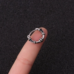 Retro silver stainless steel segment hoop ring with black enamel texture on fingertip