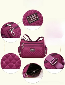 Detailed view of quilted nylon shoulder bag with multiple zip pockets and adjustable strap