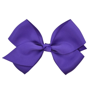 Detailed macro view of dark purple grosgrain ribbon texture on multi-layered kids hair bow