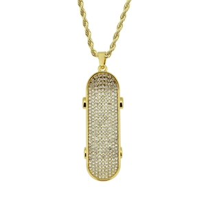 Macro detail of iced-out skateboard pendant with sparkling rhinestones on golden chain
