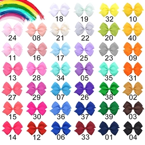 Detailed grid of 40 solid grosgrain hair bows for children in assorted vibrant colors