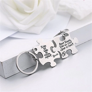 Close-up of puzzle-shaped friendship keychains with side by side or miles apart engraving