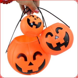Three orange plastic Halloween pumpkin lanterns in large, medium and small sizes