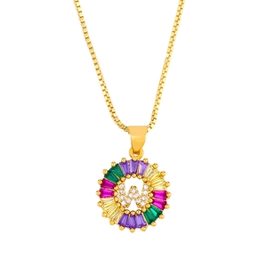 Macro shot of gold letter W pendant with multicolor zircon baguettes and box chain