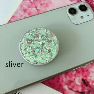 Detail showing round grip with green crystal and silver foil on light green phone case