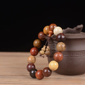 Detailed view of 15mm mixed redwood beads bracelet with a decorative Chinese knot