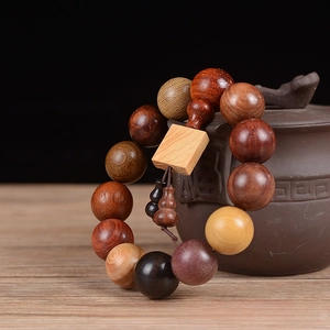 Close-up of 18mm multi-wood beads bracelet with square charm and gourd accents