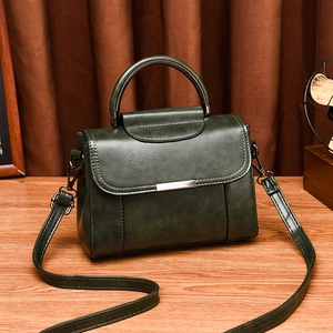 Vintage dark green oil wax leather handbag with top handle and crossbody strap