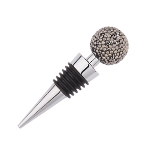 Macro detail of wine stopper with a diamond-studded crystal ball and rubber seal
