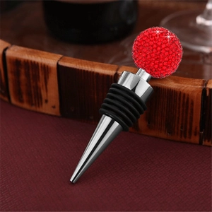 Close-up of a red crystal ball wine stopper with zinc alloy and rubber seals on a table