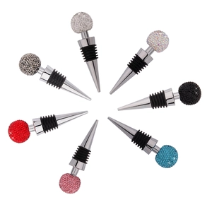 Set of eight zinc alloy wine stoppers with colorful crystal balls on white background