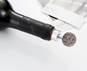 Detail shot of the rhinestone wine stopper with a sparkling crystal ball and silver finish