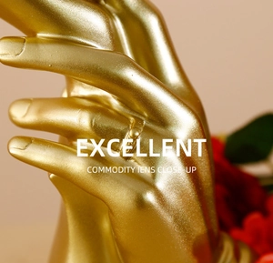 Close-up of golden hand-shaped resin ornament with glossy metallic finish and ring detail