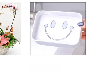 Detail of white plastic soap box with cute smiley face drainage holes for bathroom