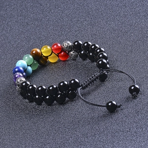 Macro shot of double-row seven chakra energy beads with black stone and adjustable cord