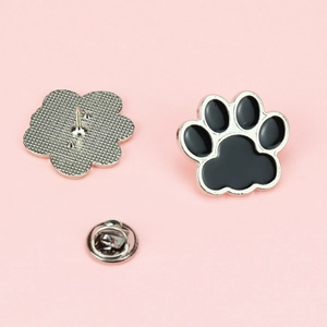 Cute black cat paw enamel pin with silver metal base and butterfly clutch backing