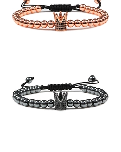 Detail of rose gold and gunblack crown bracelets with micro-pave zircons and braided rope