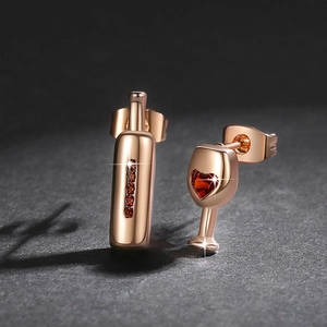 Asymmetric rose gold wine bottle and glass earrings with red heart stones