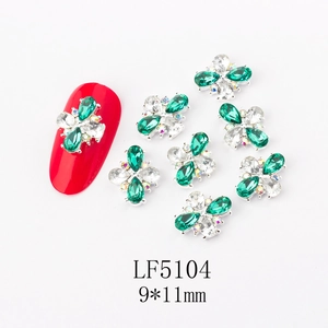 Macro shot of 3D emerald green flower nail art jewels with rhinestones 9x11mm