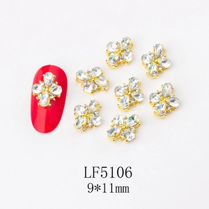 Macro shot of gold floral nail art charms with crystals, 9x11mm 3D flower decoration