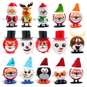 Detailed array of fifteen colorful clockwork Christmas wind-up toys on white background