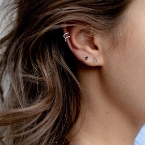 925 silver hollow star stud earrings and ear cuff set worn by a female model