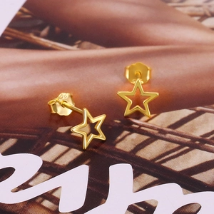 Detail shot of golden S925 sterling silver hollow star earrings with engraved hallmark