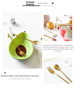 Close-up of golden stainless steel spoons with creative fruit charms in a ceramic bowl