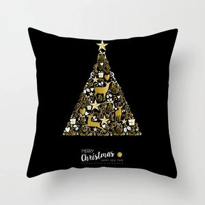 Détail de la housse de coussin de Noël noir et or avec arbre festif et texte