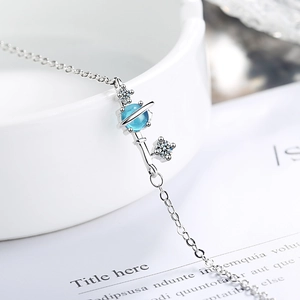 Celestial dream planet bracelet with blue gemstone and silver magic wand pendant