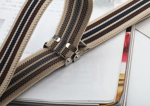 Macro shot of blue and brown striped elastic stretch belt with silver metal buckle
