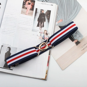 Detail of red white and blue elastic waist belt with a golden interlocking ring buckle