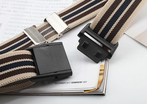 Detail of striped elastic belt with beige, brown, and navy weave and black buckle