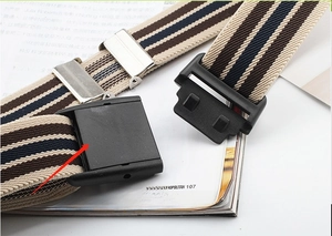 Detail of striped elastic belt showing black plastic buckle and metal adjustment clip