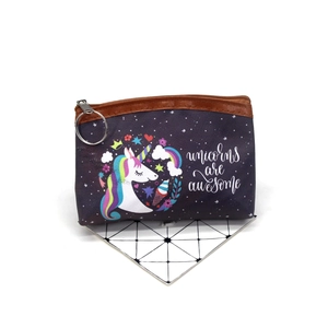 Detail of purple unicorn coin purse with zipper closure and cute graphic prints