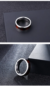 Detailed close-up showing the silver stainless steel ring with elegant dark wood inlay