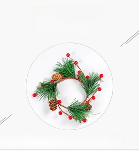 Close-up of artificial Christmas wreath with green pine needles, red berries and pine cones
