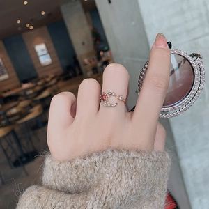 Detail of rose gold moon and star ring with micro-pave crystals on model hand
