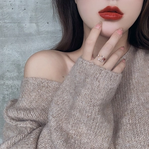 Detail of star and moon open ring with red stone inlay on a model's hand