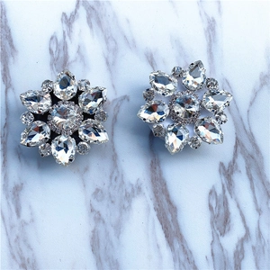 Macro shot of snowflake crystal charms with pear-cut rhinestones and silver alloy base