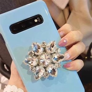 Close-up of light blue phone case with luxury floral crystal ring stand and rhinestones