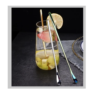 Detailed close-up of colorful long-handle stainless steel mixing spoons in a glass