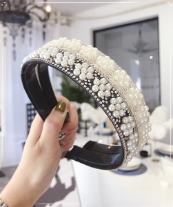 Detailed close-up of handmade pearl headband featuring sparkling rhinestones and white pearls
