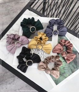 Detailed view of satin bow scrunchies with rhinestone rings in various elegant colors