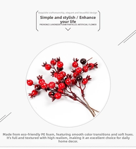 Detail of realistic red artificial pomegranate berry branch for Christmas wreath DIY