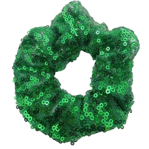 Sparkly green sequin scrunchie hair tie for women with elastic band on white background